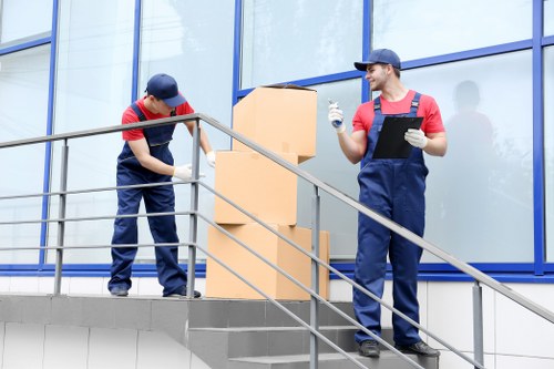 Local removals crew handling furniture in Peckham