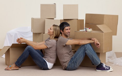 Trained moving staff handling boxes with care in Peckham