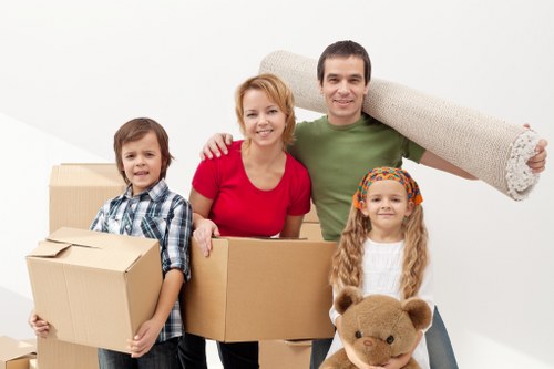 Removal professionals carrying furniture during a Peckham house move