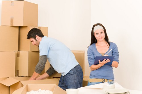 Professional moving crew working safely with van loading and secure transport