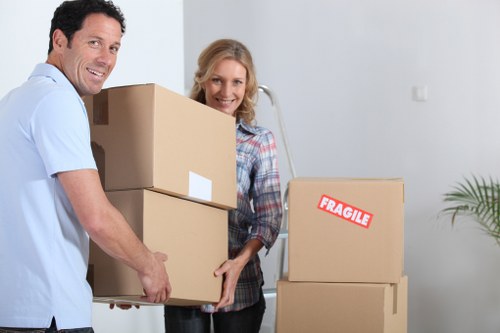 Local movers organising fragile household items for transport in Peckham