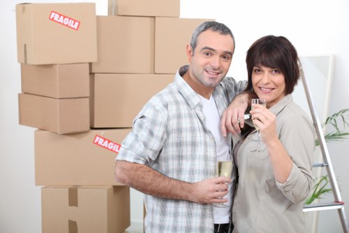 Trained movers handling furniture carefully during a Peckham van service