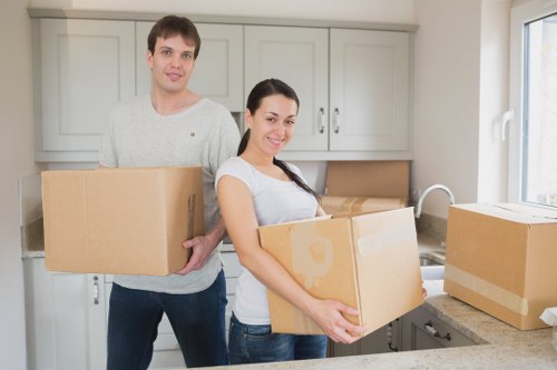 Professional movers loading furniture into a removal van in Peckham